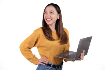 Portrait of a happy asian businesswoman holding laptop computer and looking away isolated over white background.