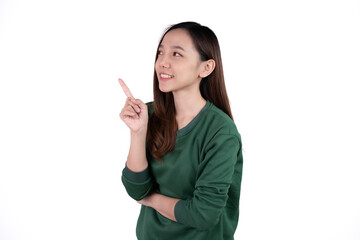 Young beautiful smiling good mood positive girl pointing finger in copyspace isolated on white background.