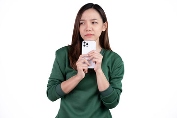 Portrait of a smiling casual asian woman holding smartphone over white background.