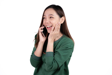 Portrait of a smiling casual asian woman holding smartphone over white background.