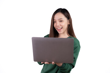 Naklejka premium Portrait of an excited young asian girl holding laptop computer and celebrating success isolated over white background.