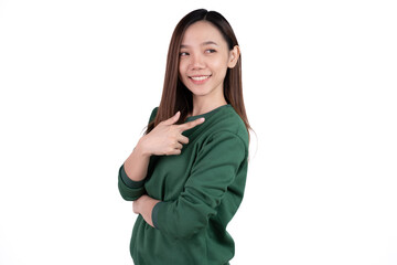 Young beautiful smiling good mood positive girl pointing finger in copyspace isolated on white background.