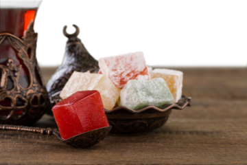 Arabic traditional sweets and berry with tea on plate