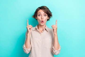 Portrait closeup photo of young bob brown hair employer woman pouted lips unexpected reaction good news fingers point up isolated on cyan color background