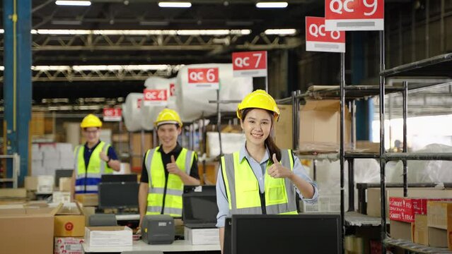 Asian warehouse worker in distribution center in packing point confidently standing with arms crossed, teamwork, warehouse, distribution, logistics
