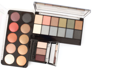 Box with eyeshadows, powder palette on white background.