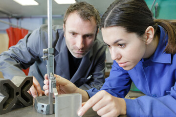 female apprentice with professional metallurgist