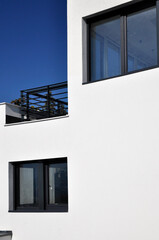 detail of a modern white residential building with blue sky