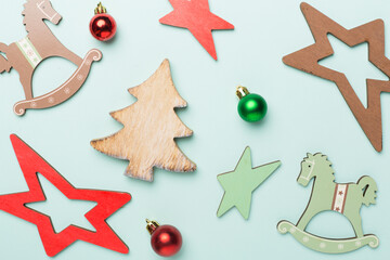 Wooden Christmas toys on color background, top view