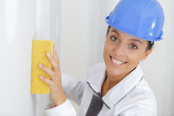 female builder washing the wall