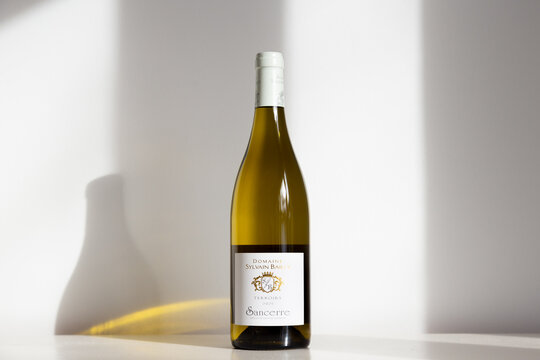 Quebec City, Quebec, Canada, December 1, 2022 - Bottle of Domaine Sylvain Bailly 2021 Sancerre wine set on plain cream background in sunlight
