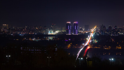 Fototapeta na wymiar Night city lights and bridge through the river