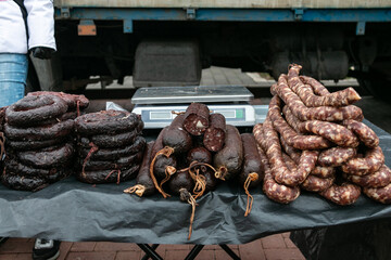 Blood sausage and cured homemade sausage on the counter of the village market. Natural food.