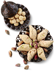 Bronze plate with date nuts and arabian sweet on the background. Ramadan kareem.