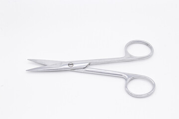 Straight surgical scissors on white background