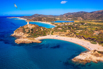 Torre di Chia view from flying drone. Acropoli di Bithia with Torre di Chia tower on background. Aerial view of Sardinia island, Italy, Europe. Panorama Of Chia Coast, Sardinia, Italy.