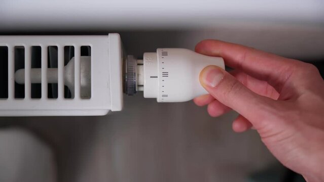 Temperature controller on the radiator. Heating of the apartment in the cold season. Selective focus