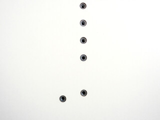 Screws screwed into the white surface. Furniture fittings