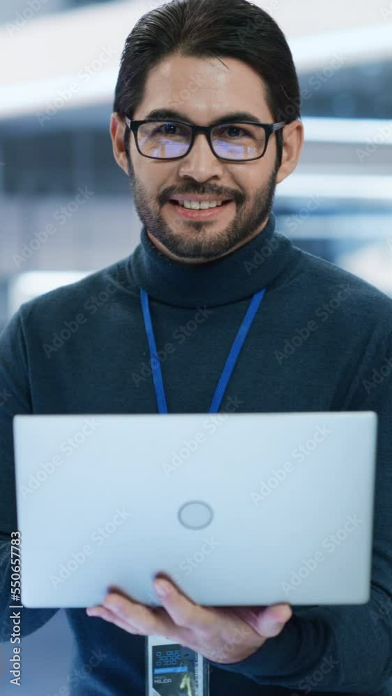 Poster vertical screen: close up portrait of a talented latin man looking at camera and charmingly smiling.
