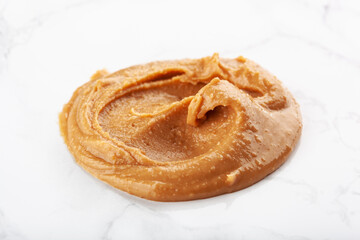 peanut butter on white marble background