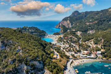 Naklejka premium Picturesque seaside of Paleokastritsa, Corfu, Greece. Beautiful bay in Paleokastritsa in Corfu island, Greece. Panoramic view of Palaiokastritsa, boats and beach Corfu, Greece