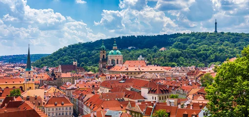 Fotobehang Top view to red roofs skyline of Prague city, Czech Republic. Aerial view of Prague city with terracotta roof tiles, Prague, Czechia. Old Town architecture with terracotta roofs in Prague. © daliu