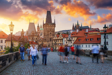 Charles Bridge in Prague with blurry tourists, Czech Republic. Charles Bridge (Karluv Most) and Old Town Tower. Vltava River and Charles Bridge. Concept of world travel, sightseeing and tourism.