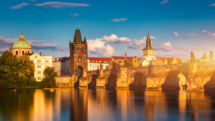 Obraz premium Charles Bridge in Prague in Czechia. Prague, Czech Republic. Charles Bridge (Karluv Most) and Old Town Tower. Vltava River and Charles Bridge. Concept of world travel, sightseeing and tourism.