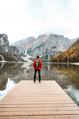 person standing on the edge of a lake