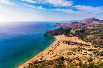 Tsampika beach with golden sand view from above, Rhodes, Greece. Aerial birds eye view of famous beach of Tsampika, Rhodes island, Dodecanese, Greece