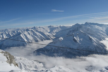 Sunny day on a Hintertux glacier (photo taken from 3250 meters above sea level) with view of Tirol Alps