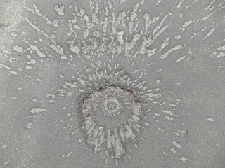 Funnel on the pavement from the explosion of a shell. Traces of the war on the asphalt road. A...