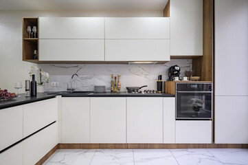 Large black and white luxury kitchen interior, whole front view
