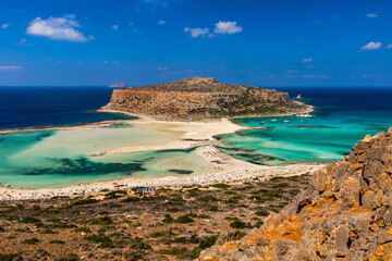 Fantastic panorama of Balos Lagoon and Gramvousa island on Crete, Greece. Cap tigani in the center. Balos beach on Crete island, Greece. Tourists relax and bath in crystal clear water of Balos beach.