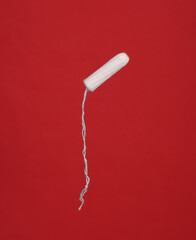 Tampon close-up on red background
