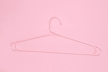 Plastic pink hanger isolated on pink background