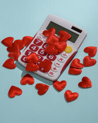 Calculator with hearts on blue background. Love concept, valentine's day, february 14th...