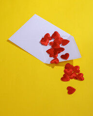 White envelope with hearts on a yellow background. Valentine's day, love concept