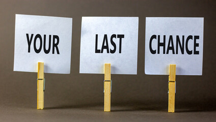 Time to your last chance symbol. Concept words Your last chance on white paper on a beautiful grey table grey background. Business and your last chance concept. Copy space.