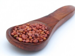 White radish seeds on wooden spoon 