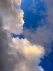 Fototapeta na wymiar Fantastic purple and orange fluffy clouds in the blue sky, heavens background