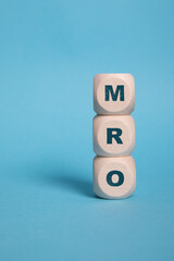 MRO, Maintenance Repair and Overhaul acronym letters on wooden blocks isolated on light Blue background copy space - obrazy, fototapety, plakaty