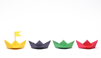 Paper colored boats on white background. Business, leadership concept