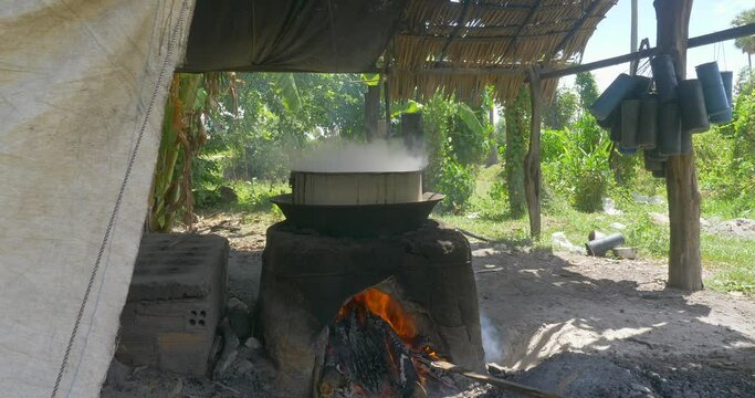 close up of a small workshop in rural area. Smoky sweetest from palm sugar boiled in large pot