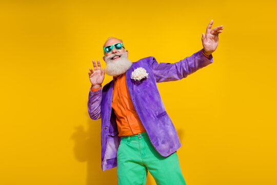 Photo portrait of nice granddad have fun clubbing dating chill fancy suit wear trendy colorful outfit isolated on yellow color background