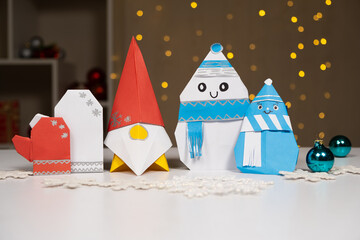 Christmas origami crafts made of paper - mittens, gnome, snowmen. DIY