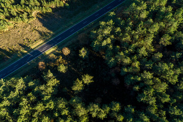 overhead drone aerial view of a road at sunset