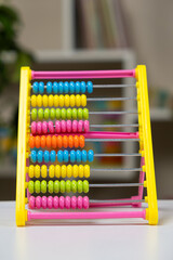 Colorful children's abacus on the table. Mathematics, arithmetic for preschool and school children, learning to count