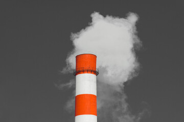 Pollution of the environment, ecology and air. Withdrawal of combustion products of soot, smoke and gases from the pipe of an industrial plant into the atmosphere against the background of a gray sky