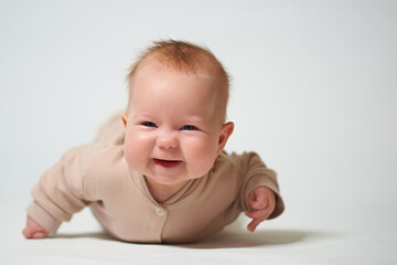 Portrait of an infant learning to crawl on a white background